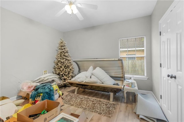 playroom with ceiling fan and light hardwood / wood-style flooring