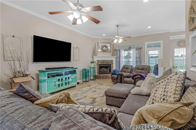 living room with a fireplace, tile patterned floors, ceiling fan, and crown molding