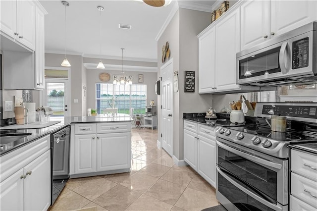 kitchen with kitchen peninsula, appliances with stainless steel finishes, crown molding, decorative light fixtures, and white cabinetry