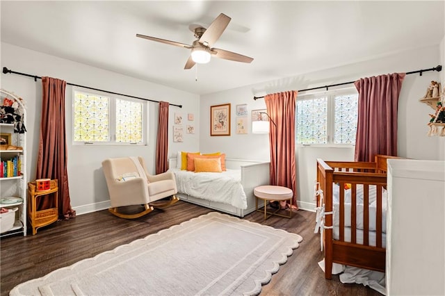 bedroom with dark wood-type flooring and ceiling fan