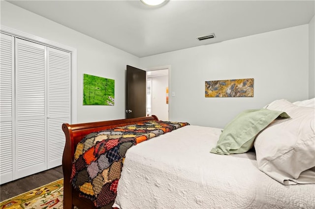 bedroom with a closet and dark hardwood / wood-style flooring