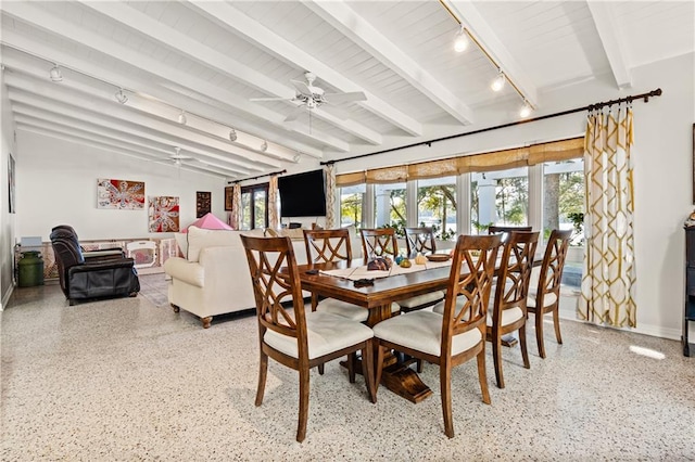 dining room with ceiling fan, lofted ceiling with beams, and track lighting