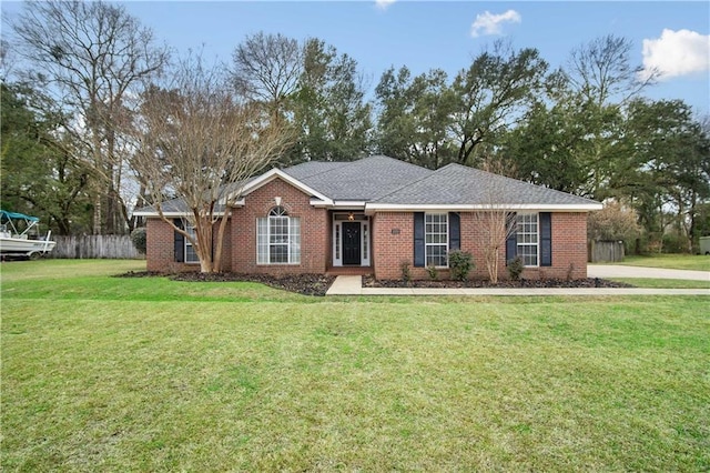 single story home featuring fence, a front lawn, and brick siding