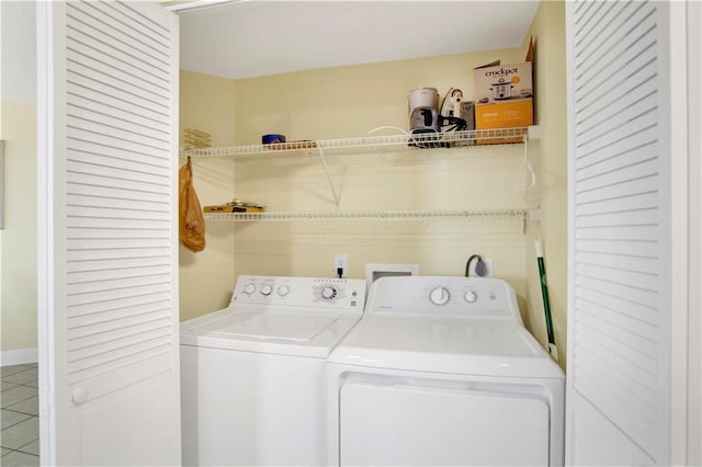laundry room featuring washer and dryer, tile patterned flooring, and laundry area