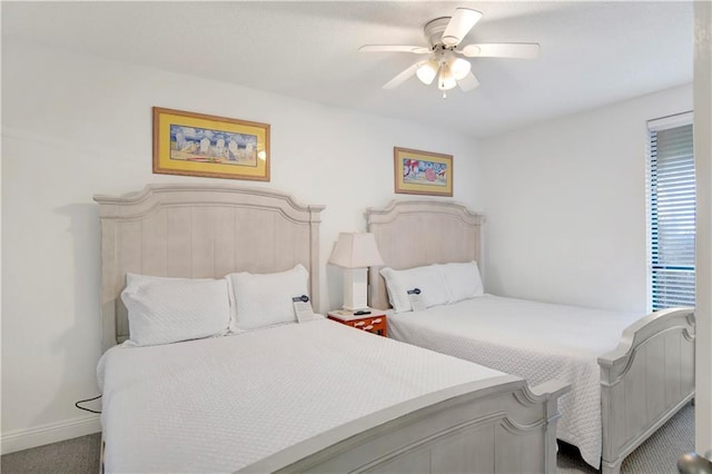 carpeted bedroom featuring ceiling fan and baseboards