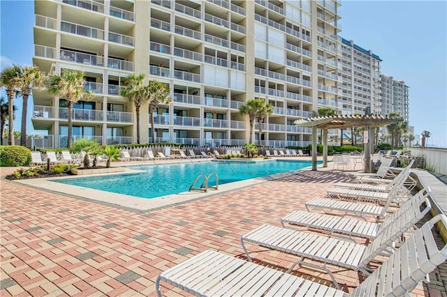 community pool featuring a pergola and a patio