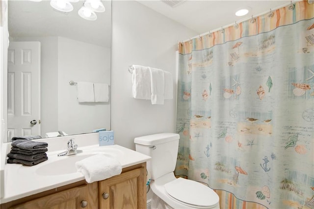 full bathroom featuring toilet, vanity, and a shower with shower curtain