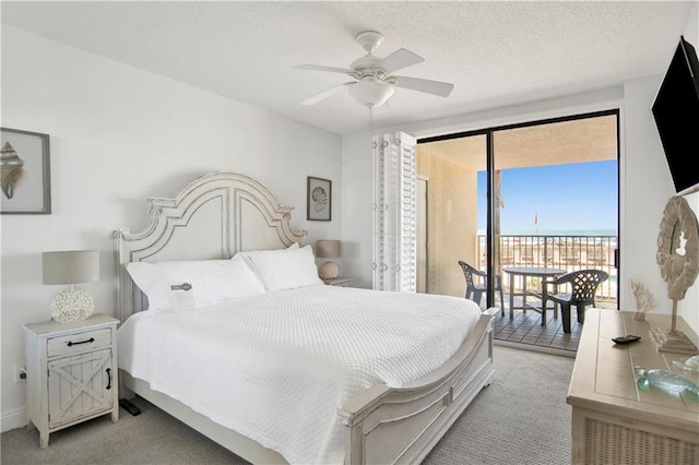 bedroom featuring access to exterior, ceiling fan, light colored carpet, and a textured ceiling