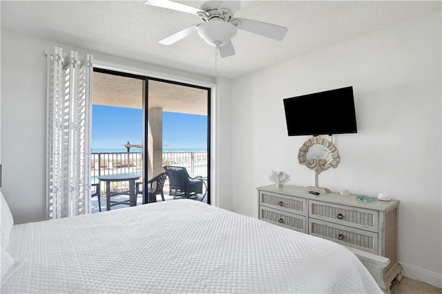 bedroom with baseboards, a ceiling fan, access to outside, and a textured ceiling