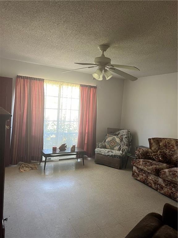 sitting room with a textured ceiling and ceiling fan