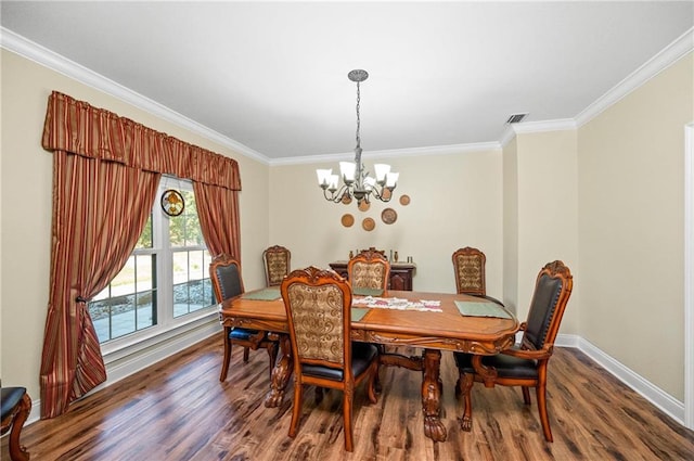 dining area with dark hardwood / wood-style floors, crown molding, and a notable chandelier