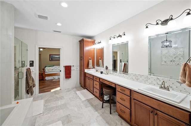 bathroom featuring a shower with door, vanity, and a chandelier