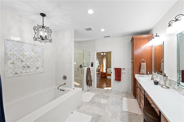 bathroom featuring vanity, plus walk in shower, and an inviting chandelier