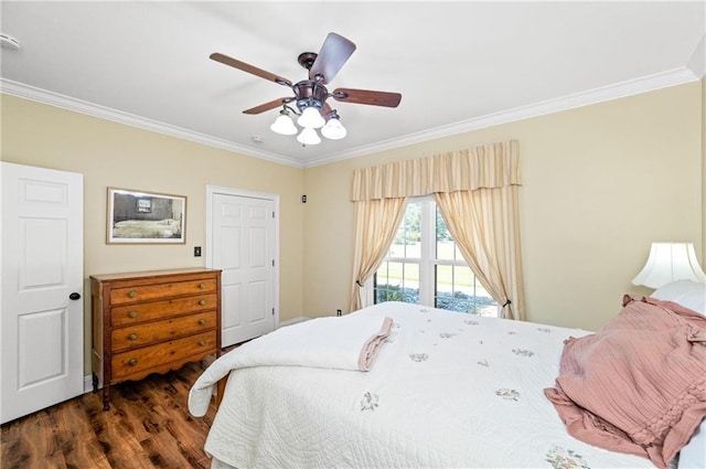 bedroom featuring dark wood-type flooring, ceiling fan, and crown molding