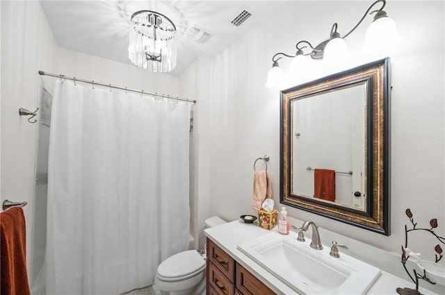 bathroom with toilet, vanity, a shower with shower curtain, and a notable chandelier