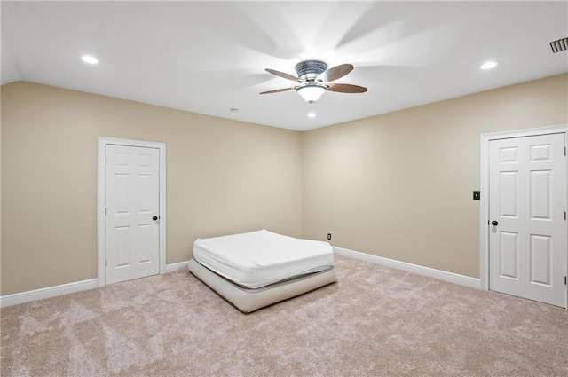 unfurnished bedroom with ceiling fan, lofted ceiling, and light colored carpet