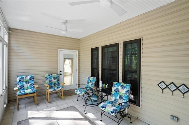 sunroom featuring ceiling fan