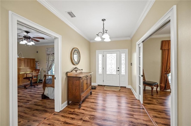 foyer with ceiling fan with notable chandelier, dark hardwood / wood-style floors, and crown molding