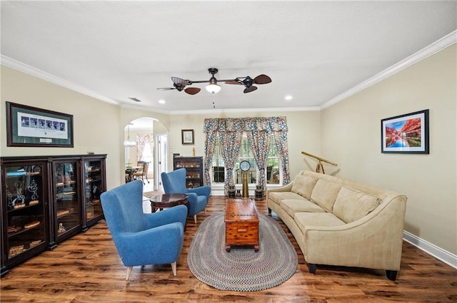 living room with hardwood / wood-style flooring, a healthy amount of sunlight, and crown molding