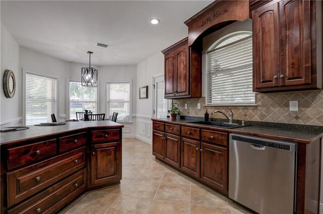 kitchen with tasteful backsplash, dishwasher, an inviting chandelier, sink, and hanging light fixtures