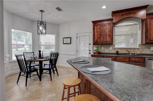 kitchen with sink, light tile patterned floors, and decorative backsplash