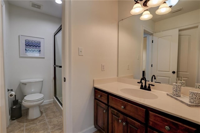 bathroom featuring vanity, toilet, and a shower with door