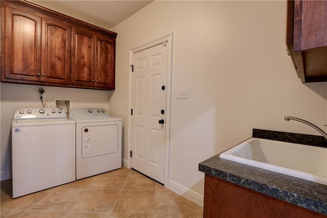 laundry area featuring cabinets, washer and clothes dryer, sink, and light tile patterned floors