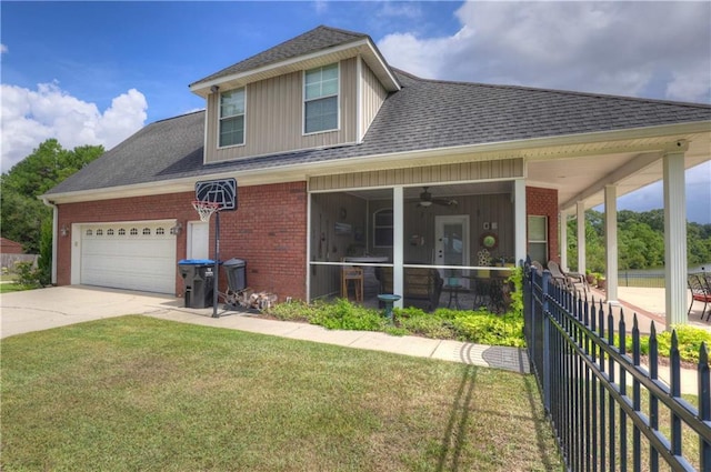 view of front of house featuring a garage, a front yard, a porch, and ceiling fan