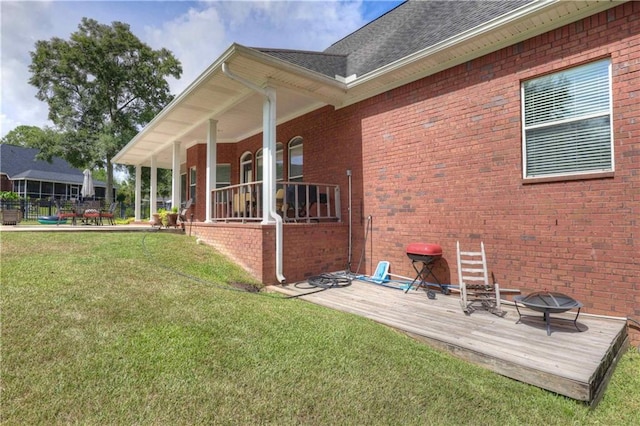 back of house with a lawn and covered porch