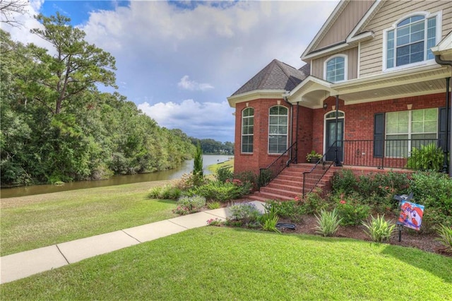 view of front of home featuring a front yard and a water view