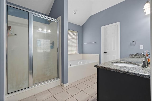 12601 Deer Ridge Dr, Wilmer, AL 36587 - bathroom with lofted ceiling, a garden tub, a stall shower, tile patterned flooring, and double vanity