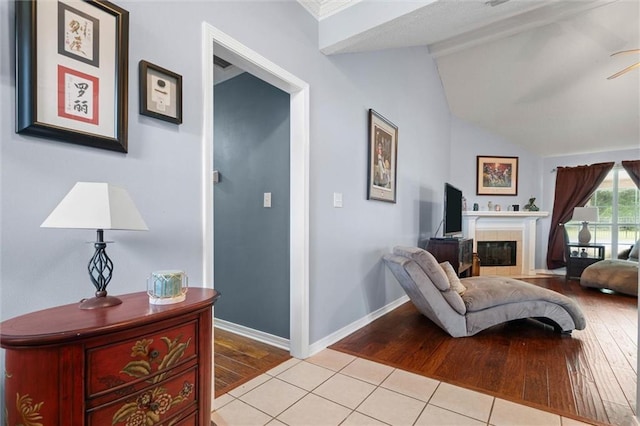 12601 Deer Ridge Dr, Wilmer, AL 36587 - living area featuring light wood-style floors, a tiled fireplace, and a ceiling fan