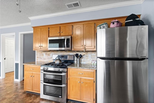 12601 Deer Ridge Dr, Wilmer, AL 36587 - kitchen with stainless steel appliances, tasteful backsplash, a textured ceiling, light stone counters, and crown molding