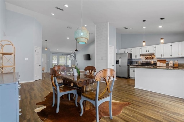 dining room with high vaulted ceiling, dark wood finished floors, recessed lighting, and baseboards