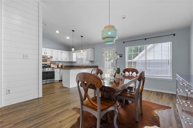 dining room with dark wood finished floors, recessed lighting, baseboards, and vaulted ceiling