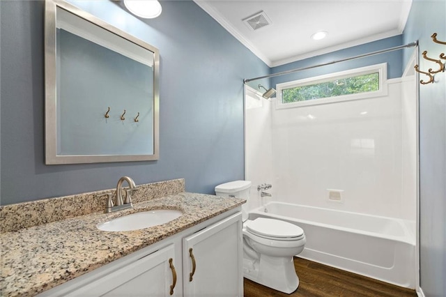 bathroom with wood finished floors, crown molding, bathing tub / shower combination, toilet, and vanity