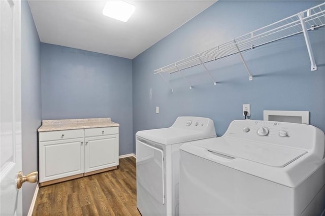 laundry area with independent washer and dryer, dark wood finished floors, baseboards, and cabinet space