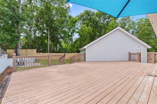 deck featuring a fenced backyard and view of wooded area