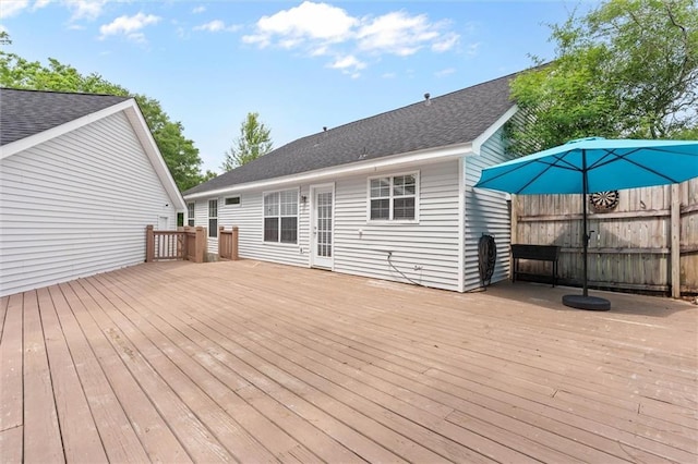wooden terrace featuring fence