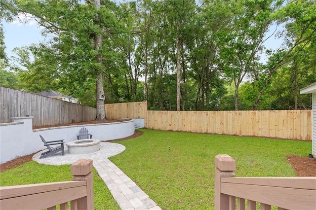 view of yard with an outdoor fire pit and a patio
