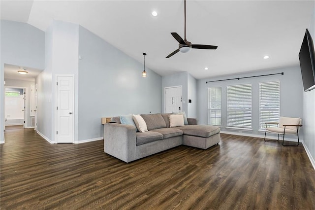 living area with ceiling fan, dark wood-style floors, baseboards, plenty of natural light, and high vaulted ceiling