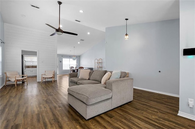 living room featuring lofted ceiling, ceiling fan, dark wood finished floors, baseboards, and recessed lighting
