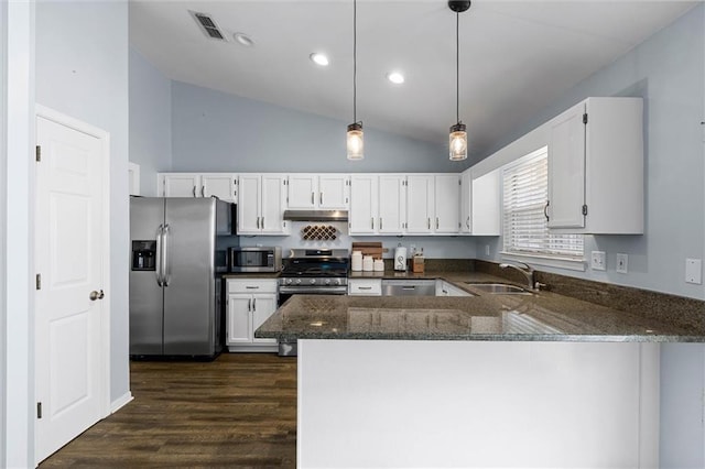 kitchen with stainless steel appliances, a sink, dark stone countertops, white cabinets, and high vaulted ceiling