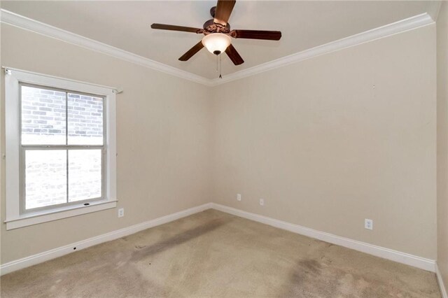 carpeted empty room with ornamental molding and ceiling fan