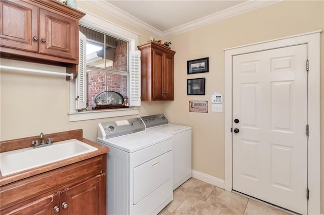 clothes washing area with washing machine and clothes dryer, cabinets, ornamental molding, and sink