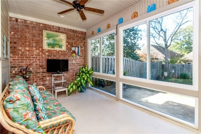 sunroom / solarium featuring ceiling fan