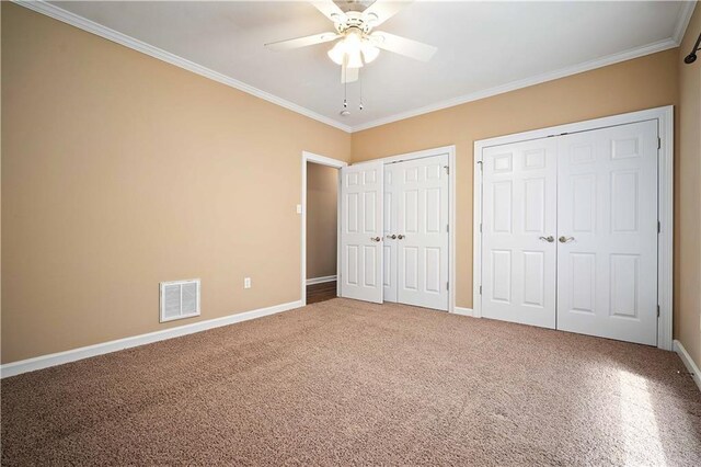 2000 Riverview Ave, Mobile, AL 36605 - unfurnished bedroom with two closets, ornamental molding, baseboards, carpet, and a ceiling fan