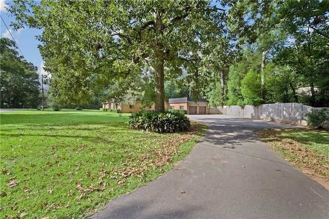 2000 Riverview Ave, Mobile, AL 36605 - view of asphalt driveway with view of wooded area