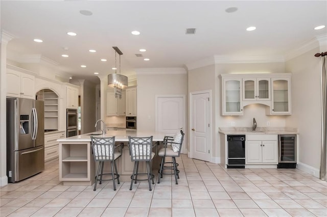 kitchen with visible vents, a sink, beverage cooler, stainless steel appliances, and open shelves