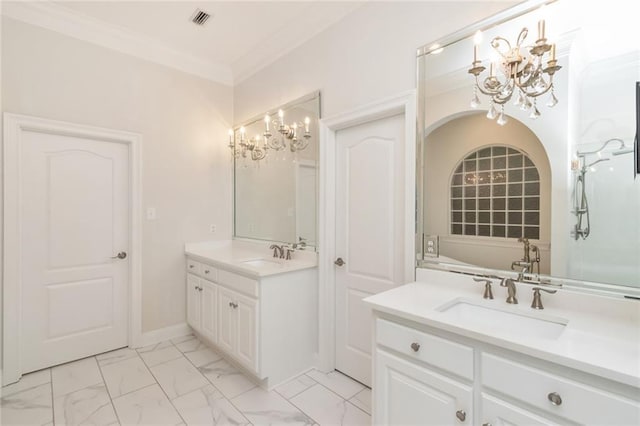 bathroom featuring crown molding, a chandelier, two vanities, marble finish floor, and a sink